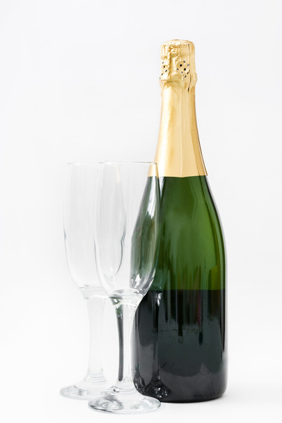 Champagne bottle with glass cups isolated on white background - Foto, afbeelding