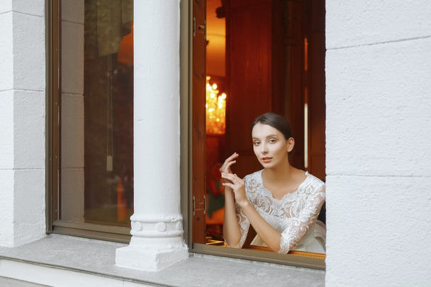 Soft focus portrait of beautiful bride looking out of the window. - Фото, зображення