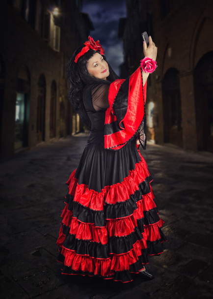 Woman in flamenco dress takes selfie photo - Fotografie, Obrázek