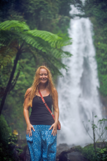 Young woman near waterfall, bali - 写真・画像
