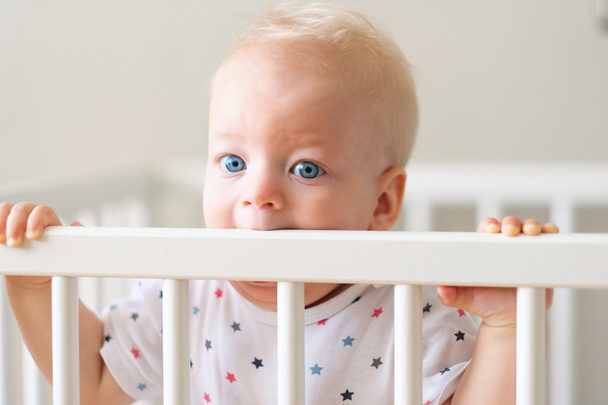 Baby standing in crib - Photo, Image
