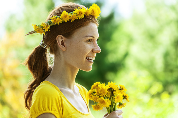 Young woman in with bouquet of dandelions - Photo, Image