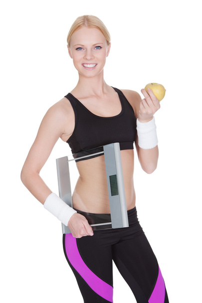 Fitness woman with weights and apple - Fotó, kép