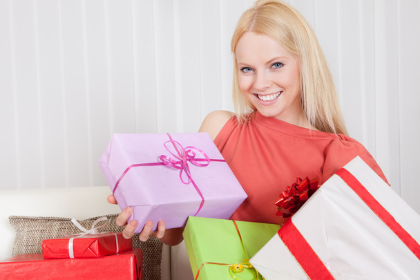 Beautiful young woman with her presents - Фото, зображення