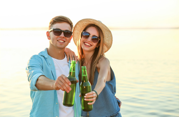 Couple hanging out with beer at the beach - Foto, immagini