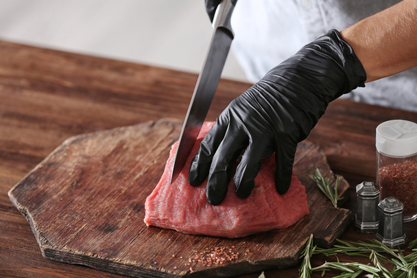 Butcher cutting pork meat - Photo, Image