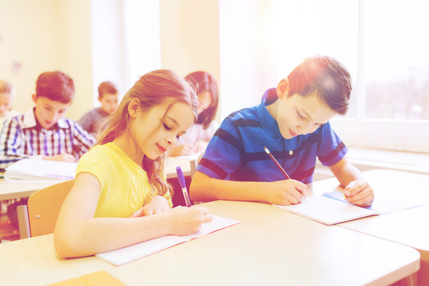 group of school kids writing test in classroom - Φωτογραφία, εικόνα