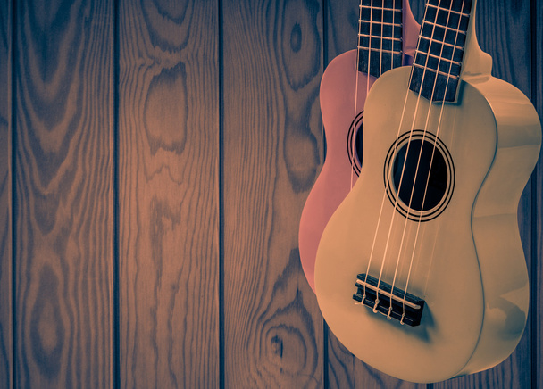 Parte de uma guitarra acústica em um fundo de madeira cinza
. - Foto, Imagem