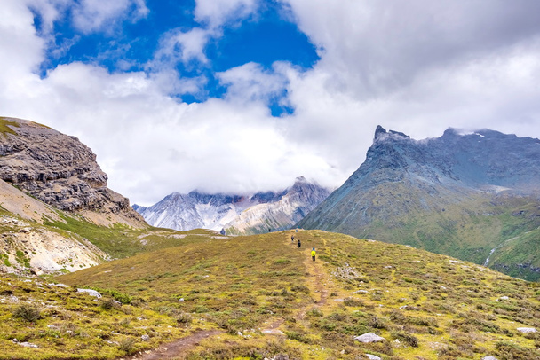 hiker hiking in Yading national level reserve in Daocheng, Sichuan Province, China. - Photo, Image