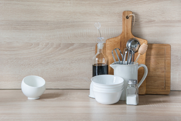  Crockery, tableware, utensils and other different stuff on wooden table-top. Kitchen still life as background for design.  Image with copy space.  - Foto, Bild