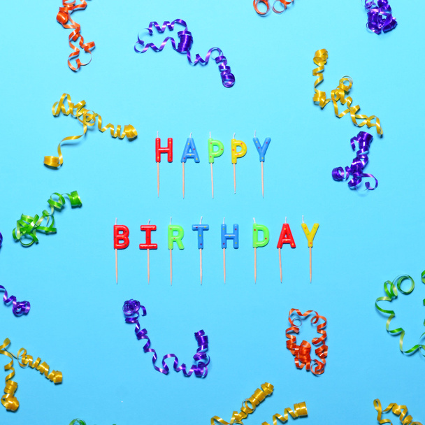 Happy Birthday flat lay party decorations on blue background - Fotó, kép