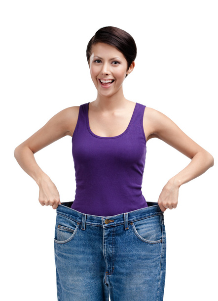 Slender woman wearing huge jeans - Foto, afbeelding