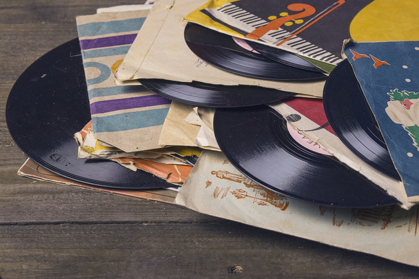 old vinyl record on the wooden table, selective focus and toned image - Photo, Image