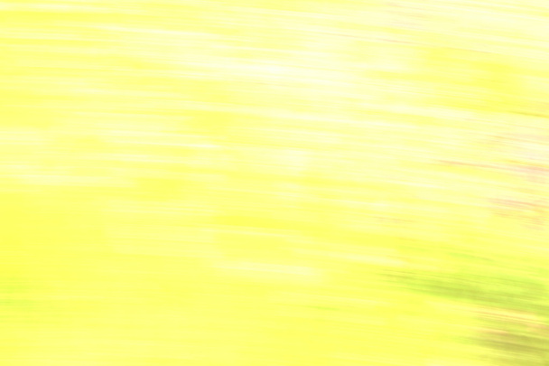 gelber verschwommener abstrakter Design-Hintergrund mit Elementen farbiger Verunreinigungen - Foto, Bild