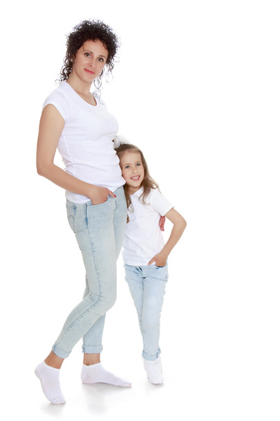 Mom and daughter in jeans  white shirts - Φωτογραφία, εικόνα