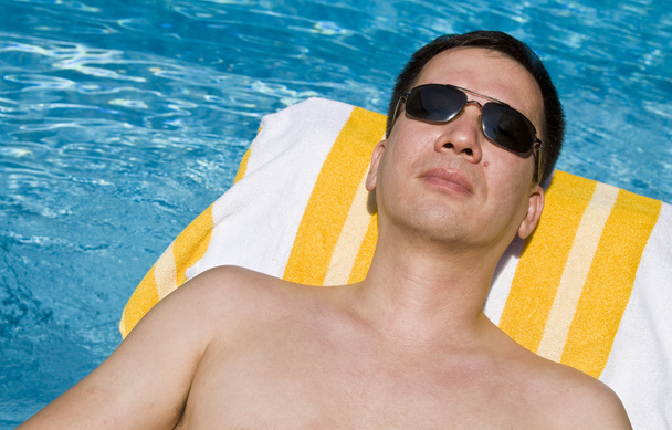 Man Lounging by the Pool - Foto, Imagen