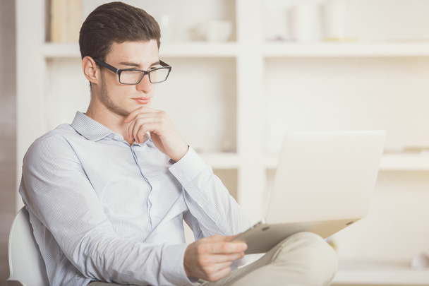Man reading something on laptop screen - Photo, Image