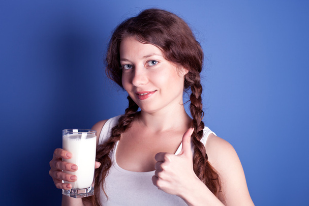 Woman enjoying a glass of milk - Foto, Bild
