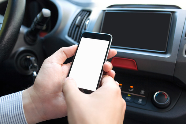 male hands inside car holding phone with isolated screen - Foto, imagen