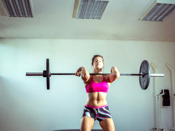 Girl doing weightlifting - Фото, изображение