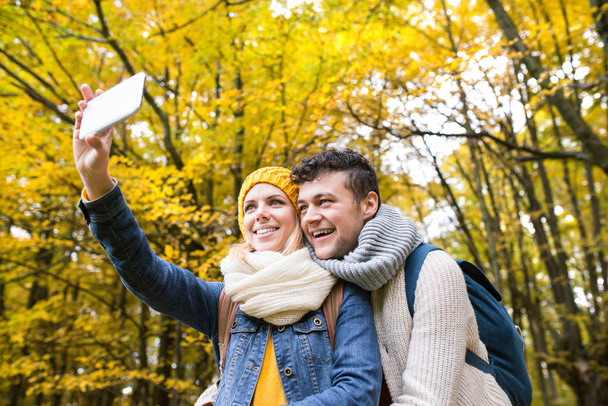young couple taking selfie in forest - Photo, Image