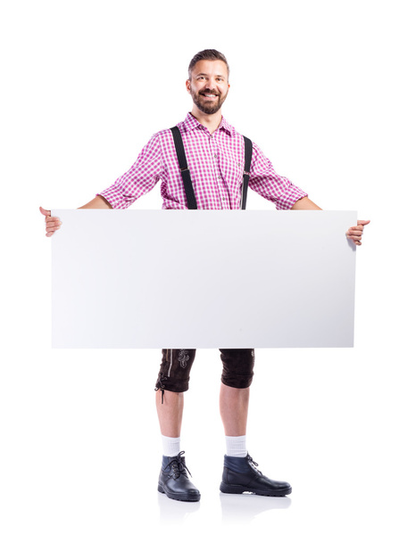 man in bavarian clothes with blank board - Foto, Imagen
