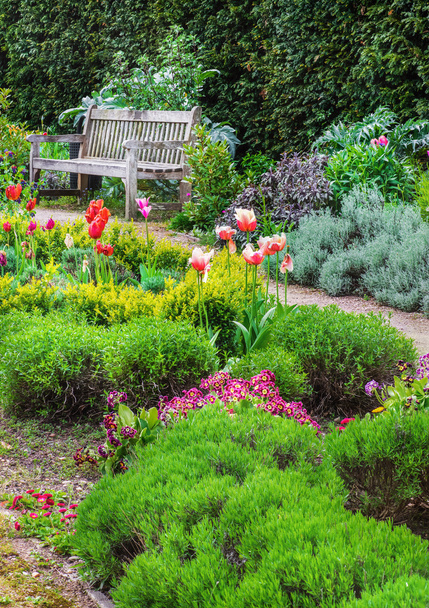  English garden with a walk path leading to empty bench  - Photo, Image