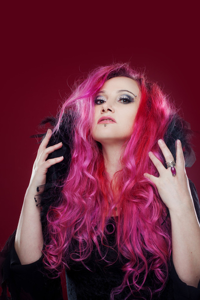 Attractive woman with pink hair in witch image. Halloween style - Фото, зображення