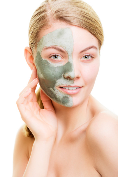Woman in clay mud mask on face isolated on white. - 写真・画像