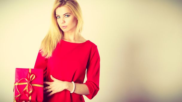 Beautiful woman with red gift. - 写真・画像