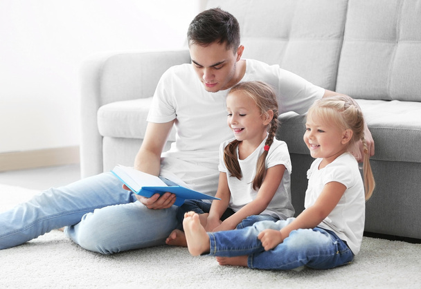 Happy father with daughters reading book - Photo, Image