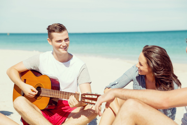 Beautiful young people with guitar on beach - Foto, immagini