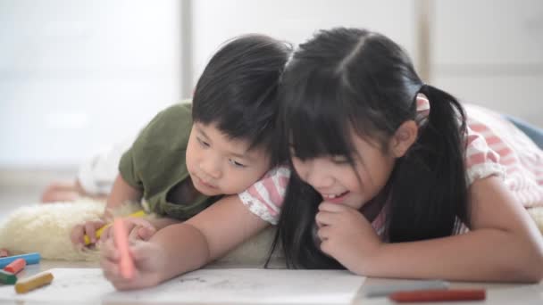 Cute Asian children drawing with crayon - Footage, Video