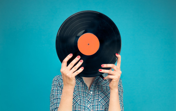 Woman holding a vinyl record  - Foto, afbeelding