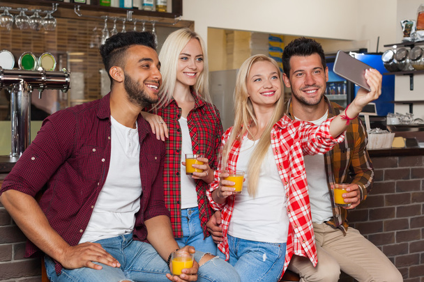 People Friends Taking Selfie Photo Drinking Orange Juice, Sitting At Bar Counter, Mix Race Man Woman Hold Smart Phone - Fotoğraf, Görsel
