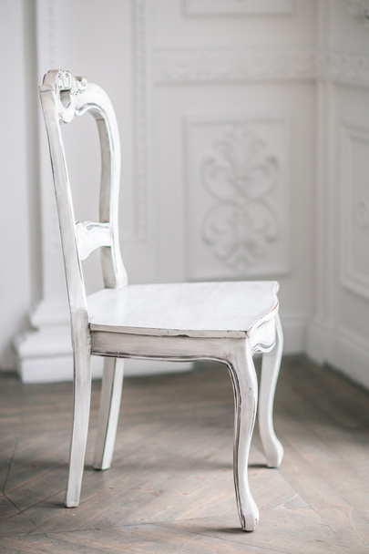 White Wooden Vintage Chair Standing in front of a White Wall on  - Photo, image