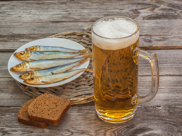 Glass of beer with a snack  - Photo, Image
