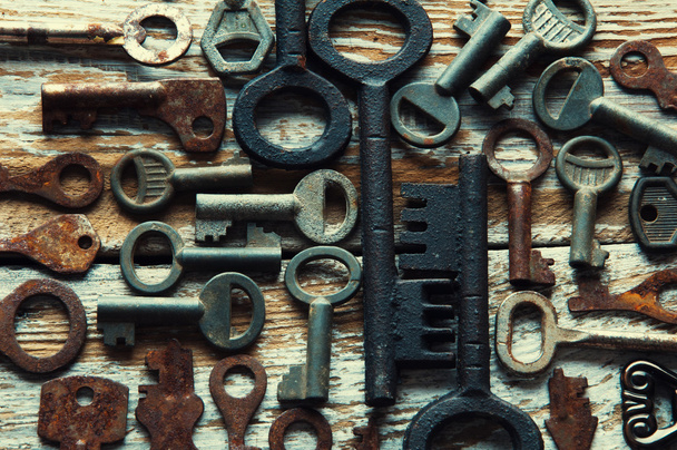 Many rusty keys and padlocks on white wood - Photo, Image