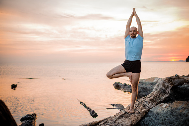 Yoga posture on sunset by man - Photo, Image