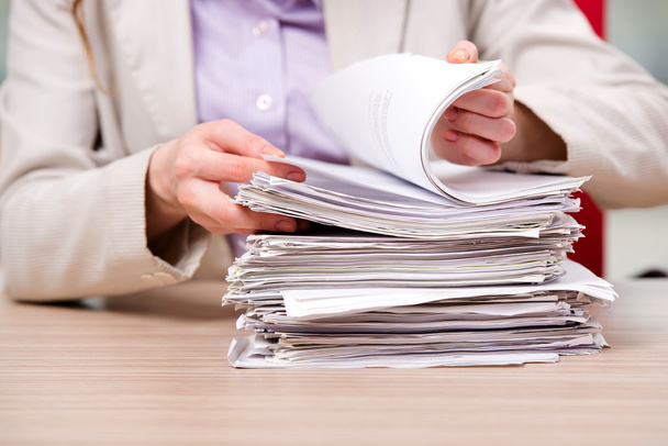 Businesswoman working with stack of papers - Photo, Image