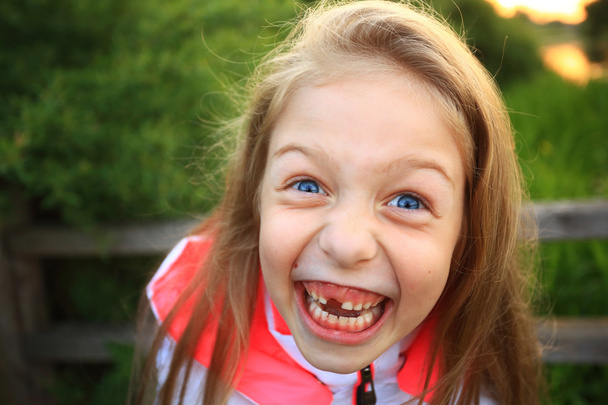 cute little girl smiling in a park close-up - Foto, imagen