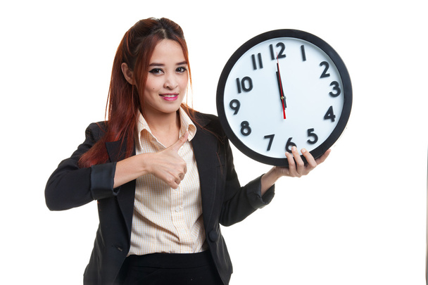 Young Asian business woman thumbs up with a clock. - Foto, Bild