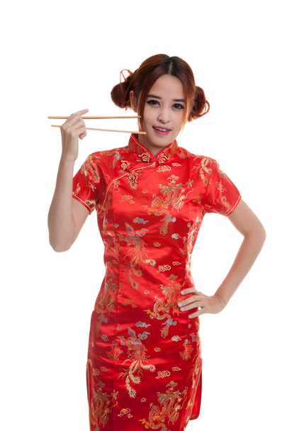 Asian girl in chinese cheongsam dress with  chopsticks. - Фото, изображение
