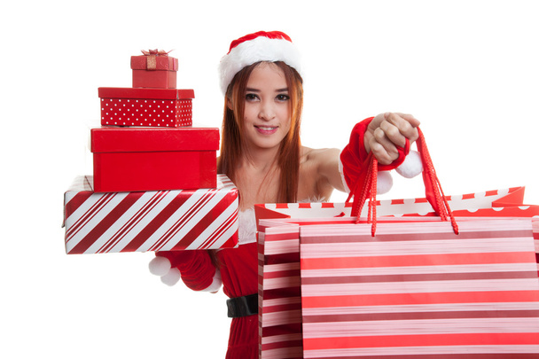 Asian Christmas Santa Claus girl with shopping bags and gift. - Photo, Image