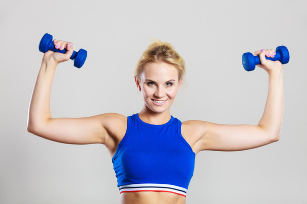Fit woman lifting dumbbells weights - Fotó, kép