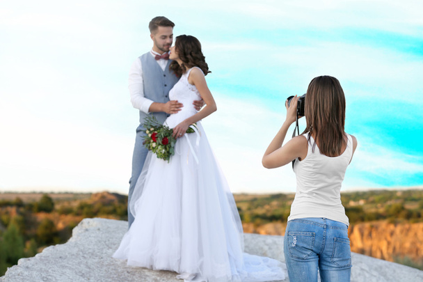 Wedding photographer taking photo of bride and groom - Zdjęcie, obraz