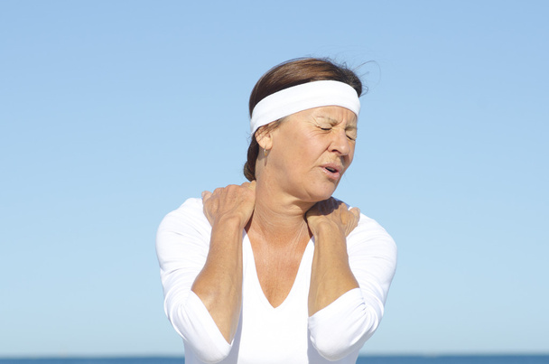Senior woman neck pain sky background - Photo, Image