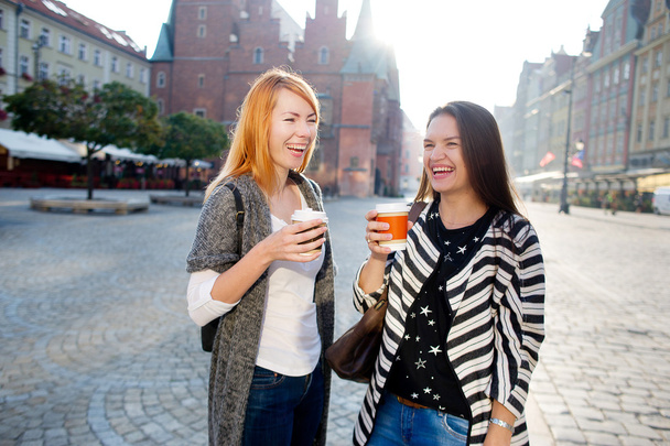 Morning. Nice young women standing on the square of the beautiful European city. - Valokuva, kuva