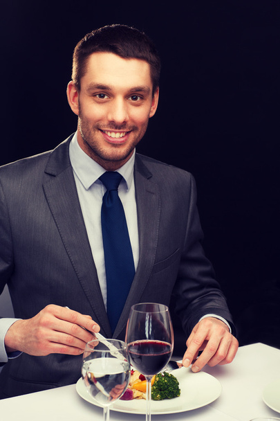 smiling man eating main course - 写真・画像