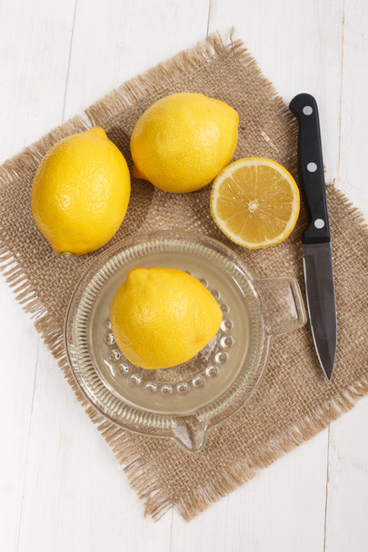 squeeze of lemon juice in a glass lemon squeezer - Photo, image